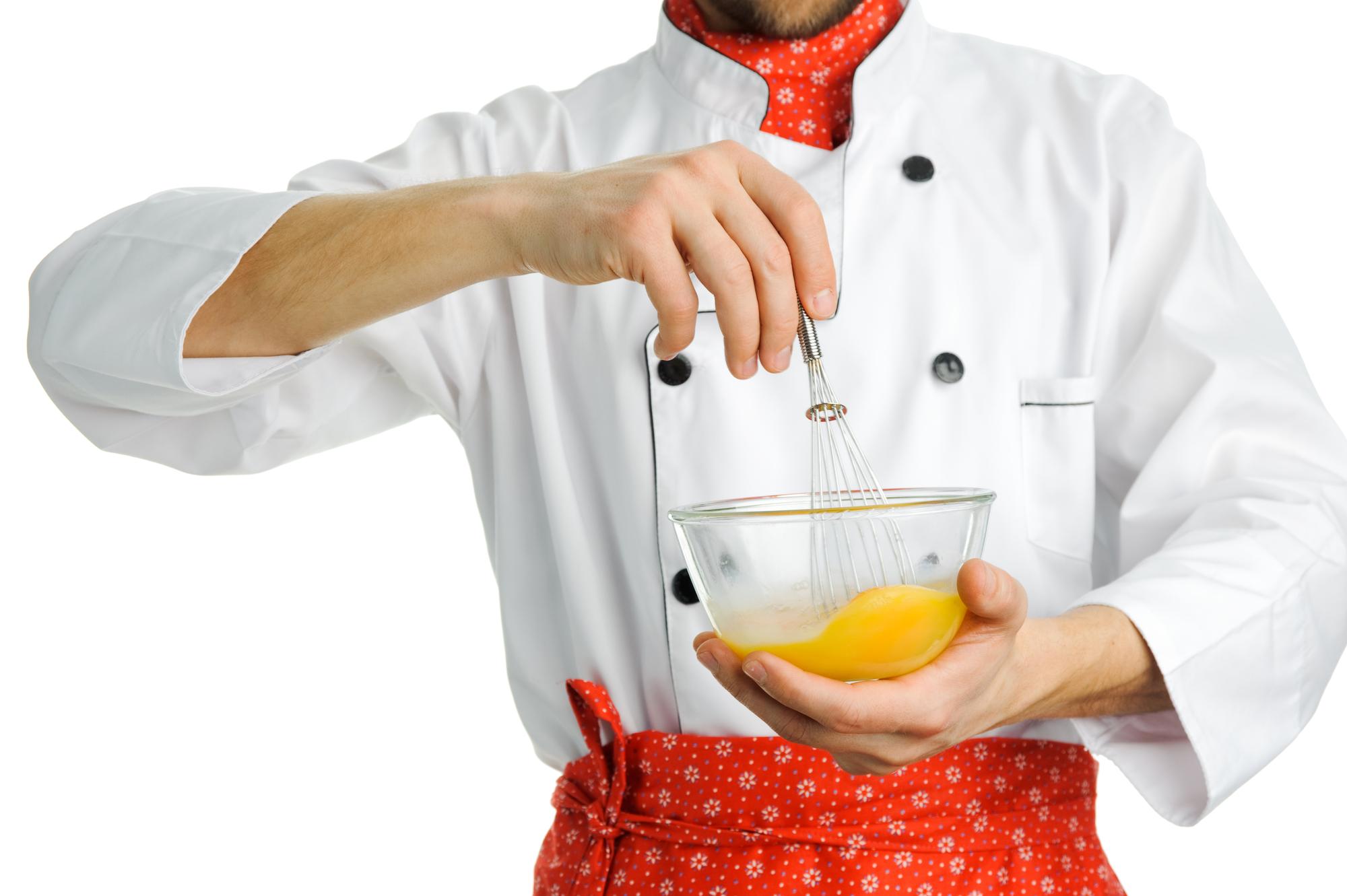 Chef demonstrating technique in warm kitchen